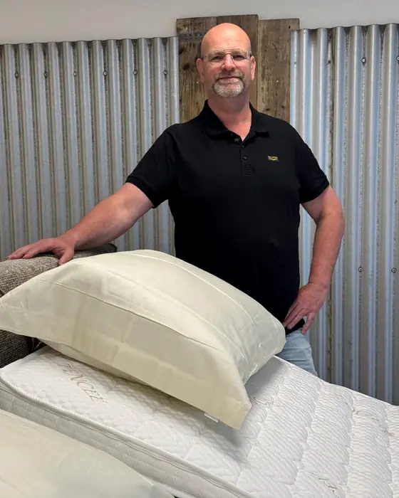 Victor Sanders in de winkel bij een matras en kussens